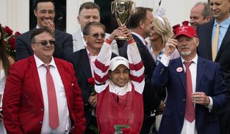 Jockey Sonny Leon celebrates after winning the 148th running of the Kentucky Derby horse race at Churchill Downs Saturday, May 7, 2022, in Louisville, Ky. On the right is owner of Kentucky Derby winning horse Rich Strike, Richard Dawson. (AP Photo/Jeff Roberson) **FILE **