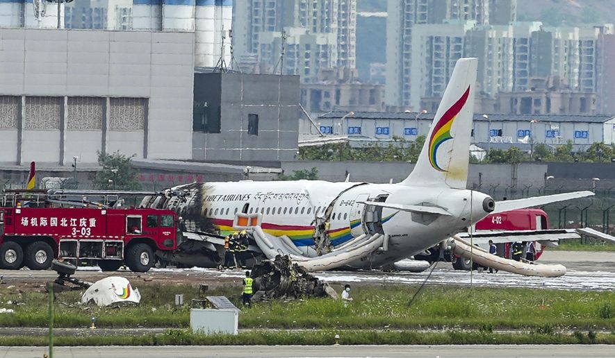 In this photo released by Xinhua News Agency, a passenger jet that veered off a runway during takeoff and caught fire is seen in the aftermath in Chongqing Jiangbei International Airport in southwestern China&#39;s Chongqing Thursday, May 12, 2022. The Chinese passenger jet left the runway upon takeoff and caught fire in western China on Thursday morning, and several people were injured. (Liu Chan/Xinhua via AP)