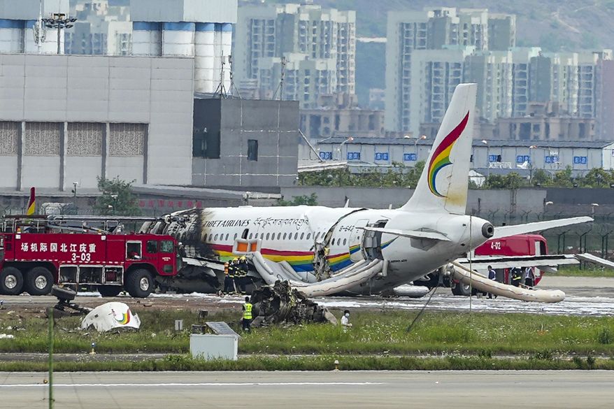 In this photo released by Xinhua News Agency, a passenger jet that veered off a runway during takeoff and caught fire is seen in the aftermath in Chongqing Jiangbei International Airport in southwestern China&#39;s Chongqing Thursday, May 12, 2022. The Chinese passenger jet left the runway upon takeoff and caught fire in western China on Thursday morning, and several people were injured. (Liu Chan/Xinhua via AP)