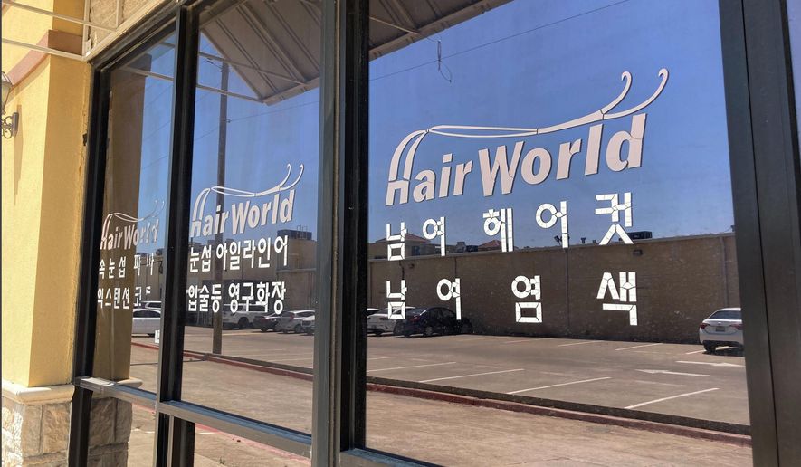 This photo shows the front of the Hair World Salon in Dallas on Thursday, May 12, 2022. Police searched Thursday for a man who opened fire inside the hair salon in Dallas&#39; Koreatown area, wounding three people. Authorities do not yet know why the man shot the three female victims Wednesday afternoon at Hair World Salon, which is in a shopping center with many businesses owned by Korean Americans. (AP Photo/Jamie Stengle)
