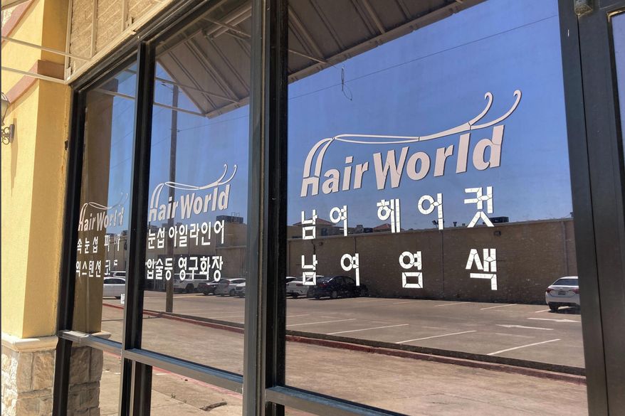 This photo shows the front of the Hair World Salon in Dallas on Thursday, May 12, 2022. Police searched Thursday for a man who opened fire inside the hair salon in Dallas&#39; Koreatown area, wounding three people. Authorities do not yet know why the man shot the three female victims Wednesday afternoon at Hair World Salon, which is in a shopping center with many businesses owned by Korean Americans. (AP Photo/Jamie Stengle)