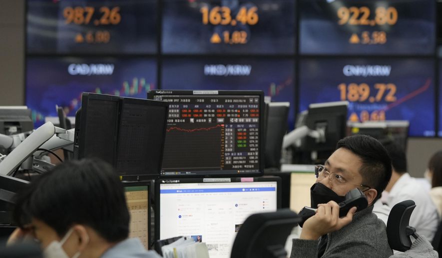 A currency trader watches monitors at the foreign exchange dealing room of the KEB Hana Bank headquarters in Seoul, South Korea, Thursday, May 12, 2022. Shares fell in Asia on Thursday after the release of worse U.S. inflation data than expected sparked heavy selling of technology stocks on Wall Street. (AP Photo/Ahn Young-joon)