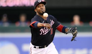 Washington Nationals shortstop Alcides Escobar throws to first to put out Houston Astros&#39; Chas McCormick during the first inning of a baseball game, Friday, May 13, 2022, in Washington. (AP Photo/Nick Wass)