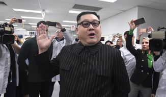 A man impersonating North Korea&#39;s leader Kim Jong-un arrives as Prime Minister Scott Morrison leaves Extel Technologies manufacturing facility on Day 33 of the 2022 federal election campaign, in Melbourne, Australia, Friday, May 13, 2022. (Mick Tsikas/AAP Image via AP)