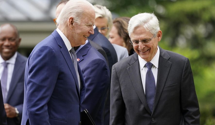 President Joe Biden walks back to the Oval Office past Attorney General Merrick Garland after speaking in the Rose Garden of the White House in Washington, Friday, May 13, 2022, during an event to highlight state and local leaders who are investing American Rescue Plan funding. (AP Photo/Andrew Harnik)