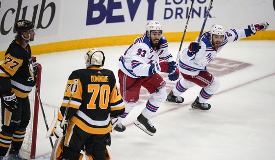 New York Rangers&#39; Mika Zibanejad (93) and Tyler Motte (64) begin the celebrate the winning goal by Chris Kreider (not shown) during the third period in Game 6 of an NHL hockey Stanley Cup first-round playoff series against the Pittsburgh Penguins in Pittsburgh, Friday, May 13, 2022. (AP Photo/Gene J. Puskar)