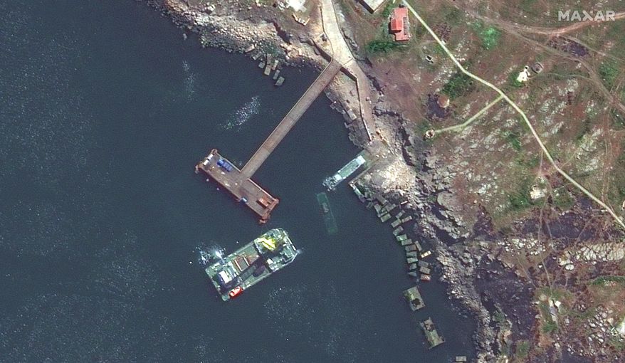 This satellite image provided by Maxar Technologies shows a closer view of barge, serna class landing craft and sunken serna craft near Snake Island in the Black Sea, Thursday, May 12, 2022. (Satellite image ©2022 Maxar Technologies via AP)