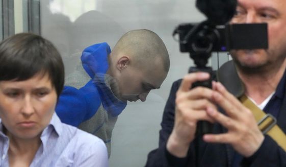Russian army Sergeant Vadim Shishimarin, 21, is seen behind a glass during a court hearing in Kyiv, Ukraine, Friday, May 13, 2022. The trial of a Russian soldier accused of killing a Ukrainian civilian opened Friday, the first war crimes trial since Moscow&#39;s invasion of its neighbor. (AP Photo/Efrem Lukatsky)