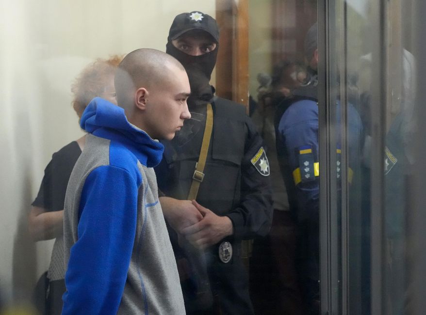 Russian army Sgt. Vadim Shishimarin, 21, is seen behind glass during a court hearing in Kyiv, Ukraine, Friday, May 13, 2022. The trial of a Russian soldier accused of killing a Ukrainian civilian opened Friday, the first war crimes trial since Moscow&#x27;s invasion of its neighbor. (AP Photo/Efrem Lukatsky)