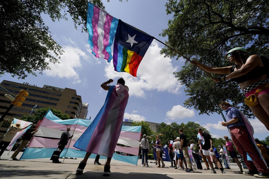 Demonstrators gather on the steps to the State Capitol to speak against transgender-related legislation bills being considered in the Texas Senate and Texas House, May 20, 2021 in Austin, Texas. The Texas Supreme Court is allowing the state to investigate parents of transgender youth for child abuse. But in a mixed ruling Friday, May 13, 2022, the court also handed a victory to one family that was among the first contacted by child welfare officials following an order by Republican Gov. Greg Abbott. (AP Photo/Eric Gay) **FILE**