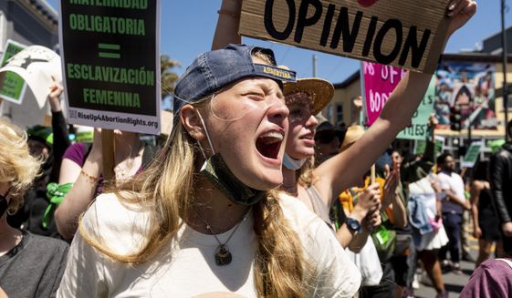 An abortion-rights protester, who declined to give her name, chants while marching through San Francisco&#39;s Mission District on Saturday, May 14, 2022. (AP Photo/Noah Berger)
