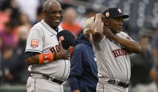 Houston Astros manager Dusty Baker Jr., left, looks on next to third base coach Gary Pettis, right, before a baseball game against the Washington Nationals, Saturday, May 14, 2022, in Washington. (AP Photo/Nick Wass)