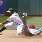 Los Angeles Angels&#39; Andrew Velazquez, right, steals second base against Oakland Athletics second baseman Tony Kemp during the fourth inning of the first baseball game of a doubleheader in Oakland, Calif., Saturday, May 14, 2022. (AP Photo/Jeff Chiu)