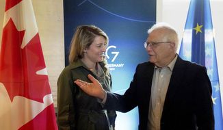 Melanie Joly, left, Foreign Minister of Canada, and Josep Borrell, right, EU High Representative for Foreign Affairs and Security Policy, talk after their bilateral meeting  during the the summit of foreign ministers of the G7 Group of leading democratic economic powers at the Weissenhaus resort in Weissenhaeuser Strand, Germany, Saturday, May 14, 2022. (Marcus Brandt/Pool via AP)