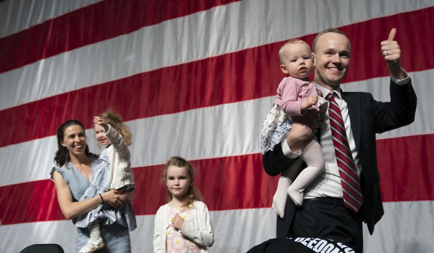 GOP attorney general candidate Jim Schultz leaves the stage with his wife Molly and their children during the first day of the Minnesota State Republican Convention, Friday, May 13, 2022,  at the Mayo Civic Center in. Rochester, Minn. (Glen Stubbe/Star Tribune via AP)