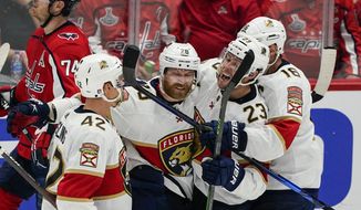 Florida Panthers defenseman Gustav Forsling, right wing Claude Giroux, center Carter Verhaeghe and center Aleksander Barkov, from left, celebrate Giroux&#39;s goal against the Washington Capitals during the third period of Game 6 of a first-round NHL hockey Stanley Cup playoff series Friday, May 13, 2022, in Washington. (AP Photo/Alex Brandon)