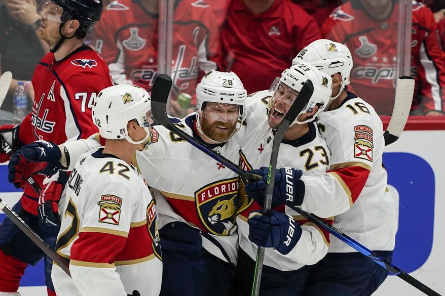Florida Panthers defenseman Gustav Forsling, right wing Claude Giroux, center Carter Verhaeghe and center Aleksander Barkov, from left, celebrate Giroux&#39;s goal against the Washington Capitals during the third period of Game 6 of a first-round NHL hockey Stanley Cup playoff series Friday, May 13, 2022, in Washington. (AP Photo/Alex Brandon)