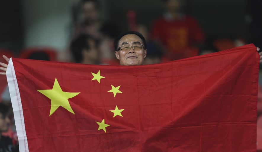 China&#39;s fan holds national flag before the AFC Asian Cup quarterfinal soccer match between Iran and China at Mohammed Bin Zayed Stadium in Abu Dhabi, United Arab Emirates, on Jan. 24, 2019. China withdrew as host of soccer&#39;s 2023 Asian Cup on Saturday, May 14, 2022, in the latest cancellation of the country&#39;s sports hosting duties during the COVID-19 pandemic. (AP Photo/Kamran Jebreili, File)