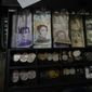 A cash register drawer holds Bolivars and U.S. currencies at a shop in Caracas, Venezuela, Friday, May 13, 2022. A new tax law approved by the Venezuelan government, that went into effect in March, applies a 3% tax charge on transactions paid in foreign currencies. (AP Photo/Ariana Cubillos)