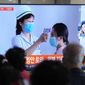 People watch a TV screen showing a news report about the COVID-19 outbreak in North Korea, at a train station in Seoul, South Korea, Saturday, May 14, 2022. North Korea on Saturday reported 21 new deaths and 174,440 more people with fever symptoms as the country scrambles to slow the spread of COVID-19 across its unvaccinated population. (AP Photo/Ahn Young-joon)