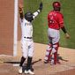 Pittsburgh Pirates&#x27; Rodolfo Castro, left, celebrates as Ke&#x27;Bryan Hayes beats out a fielder&#x27;s choice allowing Castro to score from third during the eighth inning of a baseball game against the Cincinnati Reds in Pittsburgh, Sunday, May 15, 2022. The Pirates won 1-0. (AP Photo/Gene J. Puskar)