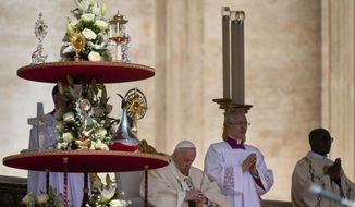 Pope Francis sits by the relics of ten new saints on the altar in St. Peter&#39;s Square at The Vatican, Sunday, May 15, 2022, where he celebrated their canonization mass. Francis created ten new saints on Sunday, rallying from knee pain that has forced him to use a wheelchair to preside over the first canonization ceremony at the Vatican in over two years. (AP Photo/Gregorio Borgia)