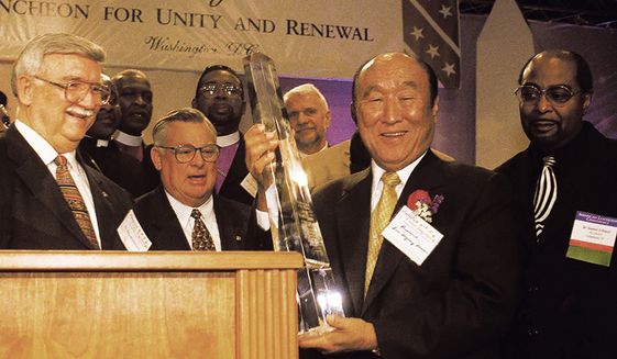 The Reverand Sun Myung Moon accepts an award from a special committee of clergy after he addressed The Inaugural Prayer Luncheon for Unity and Renewal at The Hyatt regency Hotel in Washington, DC, January 19, 2001. ( J.M. Eddins Jr. / The Washington Times )