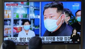 People watch a TV screen showing a news program reporting on North Korean leader Kim Jong-un, as they congregate at a train station in Seoul, South Korea, Monday, May 16, 2022. Kim blasted officials over slow medicine deliveries and ordered his military to respond to the surging but largely undiagnosed COVID-19 crisis that has left 1.2 million people ill with fever and 50 dead in a matter of days, state media said Monday. (AP Photo/Lee Jin-man)
