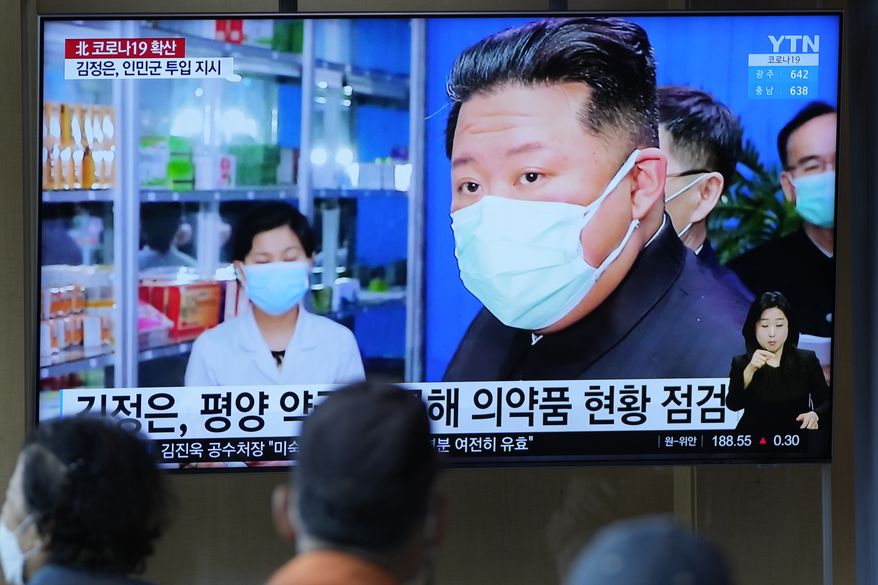 People watch a TV screen showing a news program reporting on North Korean leader Kim Jong-un, as they congregate at a train station in Seoul, South Korea, Monday, May 16, 2022. Kim blasted officials over slow medicine deliveries and ordered his military to respond to the surging but largely undiagnosed COVID-19 crisis that has left 1.2 million people ill with fever and 50 dead in a matter of days, state media said Monday. (AP Photo/Lee Jin-man)