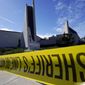 Crime scene tape is stretched across an area at Geneva Presbyterian Church in Laguna Woods, Calif., Sunday, May 15, 2022, after a fatal shooting. (AP Photo/Damian Dovarganes)