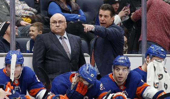 New York Islanders head coach Barry Trotz, left, and assistant coach Lane Lambert stand on the bench during an NHL hockey game against the Philadelphia Flyers on Monday, Jan. 17, 2022, in Elmont, N.Y. The New York Islanders have hired longtime Barry Trotz assistant and right-hand man Lane Lambert to succeed him as coach. General manager Lou Lamoriello announced Lambert as Trotz&#x27;s replacement Monday, May 16, a week after firing the Stanley Cup-winning coach who had one year remaining on his contract. (AP Photo/Jim McIsaac, File) **FILE**
