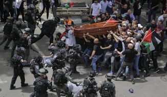 Israeli police confront mourners as they carry the casket of slain Al Jazeera veteran journalist Shireen Abu Akleh during her funeral in east Jerusalem, Friday, May 13, 2022. Latin Patriarch Pierbattista Pizzaballa, the top Catholic clergyman in the Holy Land, told reporters at St. Joseph Hospital in Jerusalem on Monday that the police beating mourners as they carried Shireen Abu Akleh&#39;s her casket was a disproportionate use of force that “disrespected” the Catholic Church. He added that Israel committed a “severe violation” of international norms. (AP Photo/Maya Levin, File)