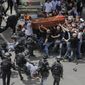 Israeli police confront mourners as they carry the casket of slain Al Jazeera veteran journalist Shireen Abu Akleh during her funeral in east Jerusalem, Friday, May 13, 2022. Latin Patriarch Pierbattista Pizzaballa, the top Catholic clergyman in the Holy Land, told reporters at St. Joseph Hospital in Jerusalem on Monday that the police beating mourners as they carried Shireen Abu Akleh&#39;s her casket was a disproportionate use of force that “disrespected” the Catholic Church. He added that Israel committed a “severe violation” of international norms. (AP Photo/Maya Levin, File)