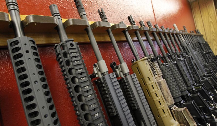 A row of rifles for sale is on display at a gun shop in Aurora, Colo., on July 20, 2012. The mass shooting in Buffalo, N.Y., has prompted questions about the effectiveness of red flag laws passed in 19 states and the District of Columbia. (AP Photo/Alex Brandon, File)
