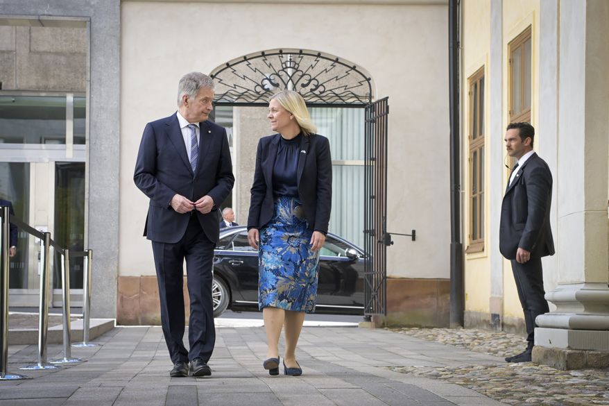 Finish President Sauli Niinisto, left, is received by Swedish Prime Minister Magdalena Andersson at the Adelcrantzska house in Stockholm, Sweden, Tuesday May 17, 2022. (Anders Wiklund/TT News Agency via AP)