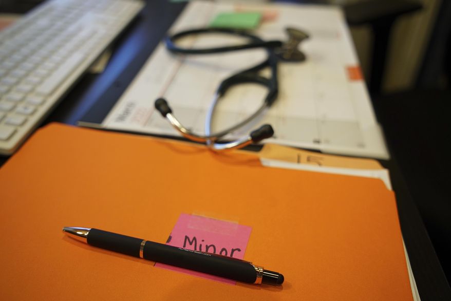 A file folder with the label &amp;quot;minor&amp;quot; sits on the desk of Dr. Leah Torres at the West Alabama Women&#39;s Center in Tuscaloosa, Ala., on Monday, March 14, 2022. The clinic is run by Robin Marty, author of a 247-page manual titled &amp;quot;The Handbook for a Post-Roe America.&amp;quot; (AP Photo/Allen G. Breed)