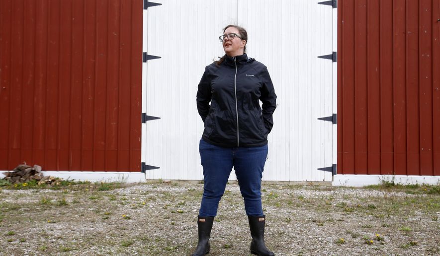 Alison Dreith stands in front of her barn in southern Illinois on Wednesday, April 13, 2022. Dreith works remotely for the Midwest Access Coalition, which pays for &amp;quot;practical support&amp;quot; for women seeking abortions. That includes things like air fare, gas money, hotel rooms or child care. Says Dreith, &amp;quot;I&#39;m kind of a freak out first, calm down later kind of person is the big energy I have. So I really appreciate that I have something — no pun intended — like, really practical to do.&amp;quot; (AP Photo/Martha Irvine)