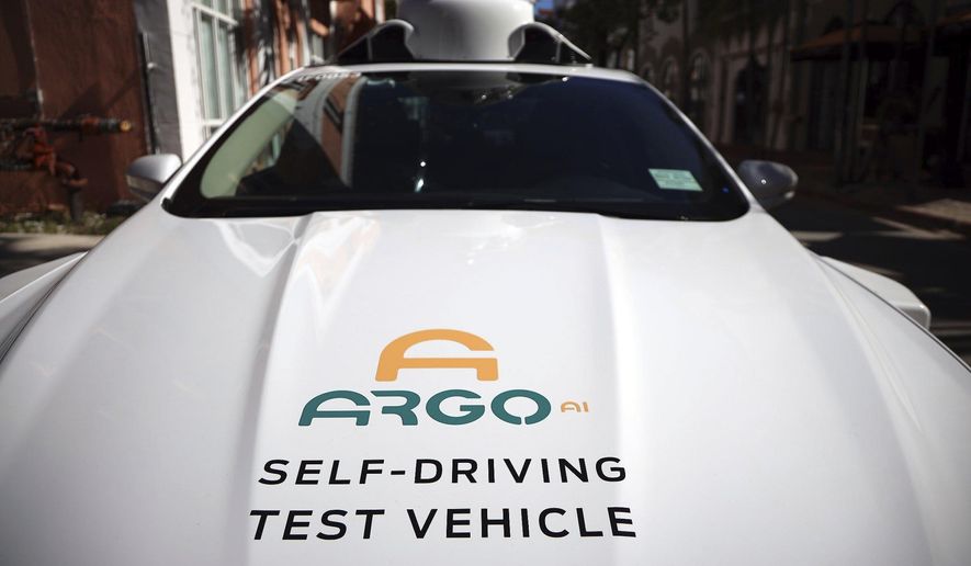 An experimental autonomous vehicle arrives for a drop-off, Dec. 8, 2020, in Miami Beach, Fla. The autonomous vehicle technology company that partners with Ford and Volkswagen says it has started driverless operations in two of eight cities where it is developing its technology. Pittsburgh-based Argo AI has pulled drivers from its autonomous cars in Miami and Austin, though it is still in the testing phase. Its commercial partnerships with Walmart and Lyft still have backup drivers in both cities. (Carl Juste/Miami Herald via AP) ** FILE **