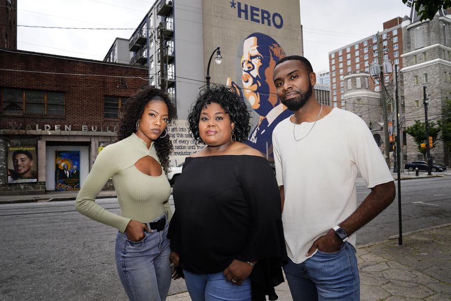 D&#39;Zhane Parker, left, Cicley Gay, center, and Shalomyah Bowers pose for a portrait on Friday, May 13, 2022, in Atlanta. (AP Photo/Brynn Anderson)