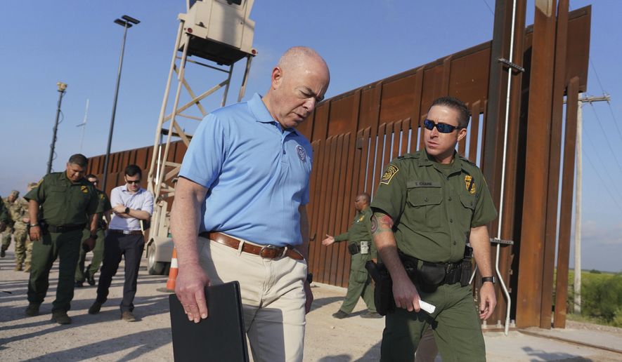 Homeland Security Secretary Alejandro Mayorkas, left, listens to Deputy patrol agent in charge of the US Border Patrol Anthony Crane as he tours the section of the border wall Tuesday, May 17, 2022, in Hidalgo, Texas. (Joel Martinez/The Monitor via AP, Pool)