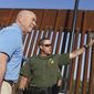 Homeland Security Secretary Alejandro Mayorkas, left, listens to Deputy patrol agent in charge of the US Border Patrol Anthony Crane as he tours the section of the border wall Tuesday, May 17, 2022, in Hidalgo, Texas. (Joel Martinez/The Monitor via AP, Pool) **FILE**