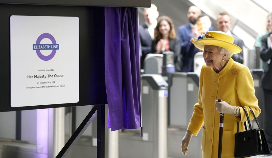 Britain&#x27;s Queen Elizabeth II unveils a plaque to mark the Elizabeth line&#x27;s official opening at Paddington station in London, Tuesday May 17, 2022, to mark the completion of London&#x27;s Crossrail project. (Andrew Matthews/Pool via AP)