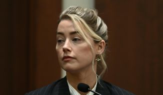 Actor Amber Heard testifies in the courtroom at the Fairfax County Circuit Courthouse in Fairfax, Va., Tuesday, May 17, 2022.  Actor Johnny Depp sued his ex-wife Amber Heard for libel in Fairfax County Circuit Court after she wrote an op-ed piece in The Washington Post in 2018 referring to herself as a &amp;quot;public figure representing domestic abuse.&amp;quot; (Brendan Smialowski/Pool photo via AP)