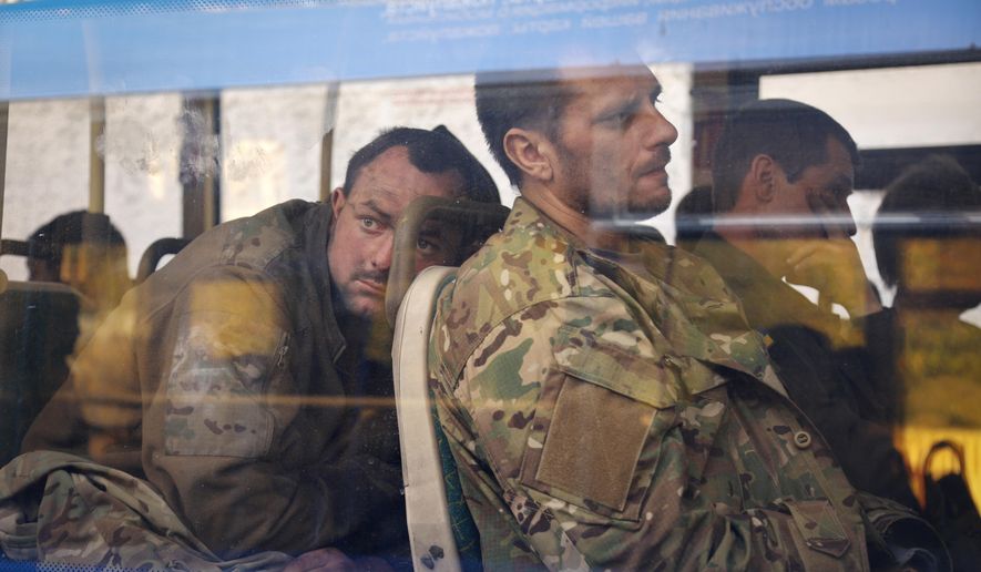 Ukrainian servicemen sit in a bus after they were evacuated from the besieged Mariupol&#x27;s Azovstal steel plant, near a remand prison in Olyonivka, in territory under the government of the Donetsk People&#x27;s Republic, eastern Ukraine, Tuesday, May 17, 2022. More than 260 fighters, some severely wounded, were pulled from a steel plant on Monday that is the last redoubt of Ukrainian fighters in the city and transported to two towns controlled by separatists, officials on both sides said. (AP Photo/Alexei Alexandrov)