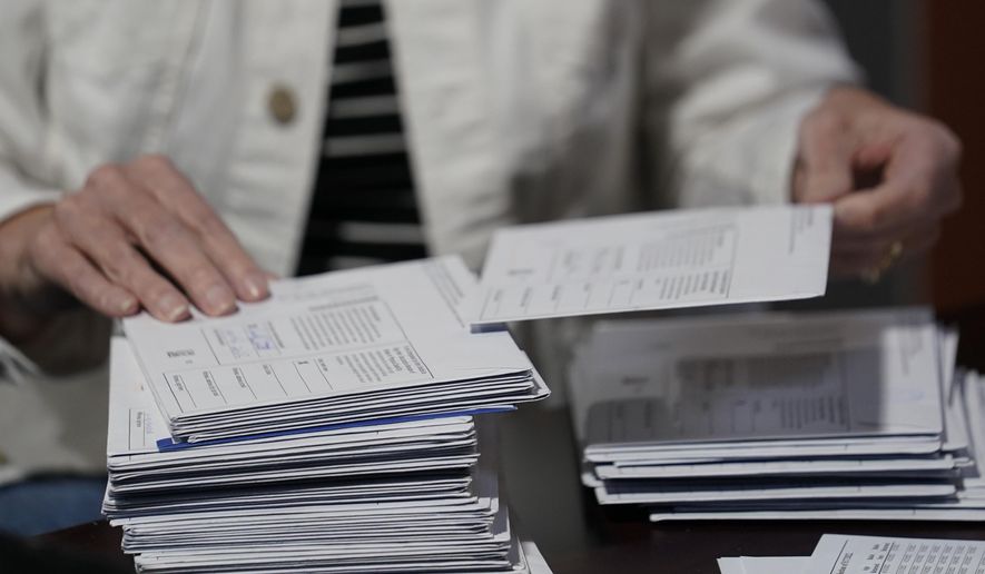 An election worker continues the process in counting ballots for the Pennsylvania primary election, Wednesday, May 18, 2022, at the Mercer County Elections Board in Mercer, Pa. Vote counting continues as Republican candidates Dr. Mehmet Oz and David McCormick are locked in a too-early-to-call race for Pennsylvania's hotly contested Republican nomination for an open U.S. Senate seat. (AP Photo/Keith Srakocic)