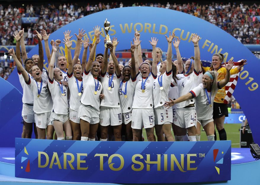 The United States&#39; team celebrates with the trophy after winning the Women&#39;s World Cup final soccer match against The Netherlands at the Stade de Lyon in Decines, outside Lyon, France, July 7, 2019. The U.S. Soccer Federation agreed to landmark collective bargaining agreements with its men&#39;s and women&#39;s teams, equalizing compensation for the first time.The CBAs announced Wednesday, May 18, 2022, run through 2028. The USSF is the first national governing body to promise both sexes matching money. (AP Photo/Alessandra Tarantino, File)