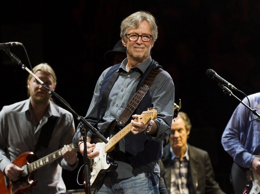 Eric Clapton performs at Eric Clapton's Crossroads Guitar Festival 2013 in New York on April 14, 2013. Clapton, a critic of coronavirus vaccines and pandemic restrictions, has tested positive for COVID-19 and canceled two upcoming European gigs. (Photo by Charles Sykes/Invision/AP, File)