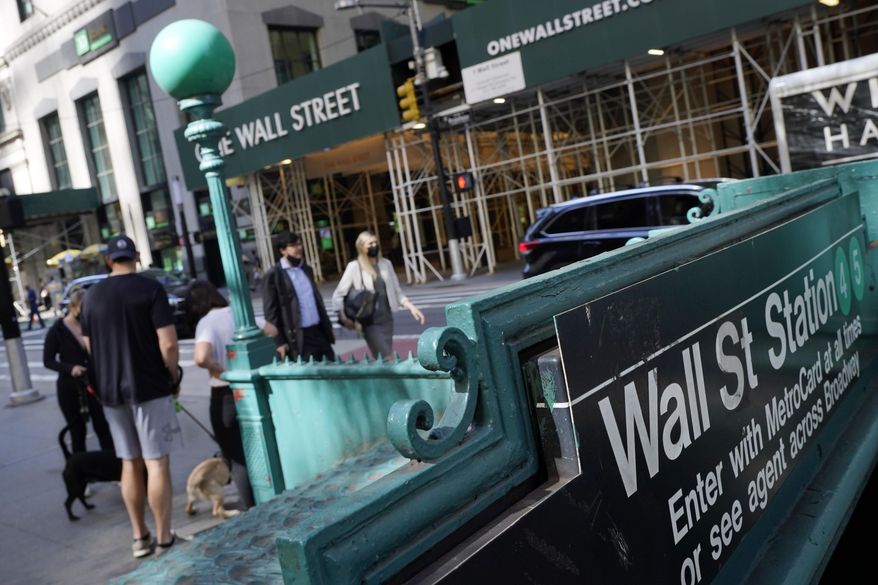 People walk on Broadway at Wall Street, Wednesday, June 16, 2021. Stocks are opening lower on Wall Street, Wednesday, May 18, 2022, led by steep drops in retailers as Target plunged after issuing a grim quarterly earnings report. (AP Photo/Richard Drew, File)