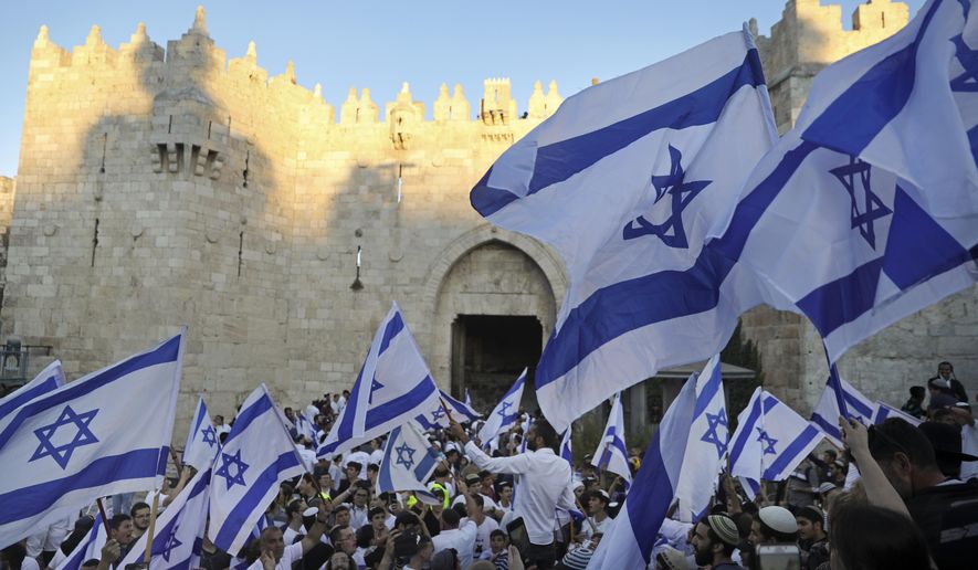 FILE - Jewish ultra-nationalists wave Israeli flags during the &amp;quot;Flags March,&amp;quot; next to Damascus gate, outside Jerusalem&#39;s Old City, June 15, 2021. Israeli authorities on Wednesday, May 18, 2022, said they have given the go-ahead for flag-waving Jewish nationalists to march through the heart of the main Palestinian thoroughfare in Jerusalem&#39;s Old City on May 29, in a decision that threatens to re-ignite violence in the holy city. (AP Photo/Mahmoud Illean, File)