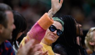 Soccer player Megan Rapinoe waves to the crowd during the second quarter of a WNBA basketball game between the Minnesota Lynx and the Seattle Storm on Friday, May 6, 2022, in Seattle. Rapinoe&#39;s fiancee, Sue Bird, plays for the Storm. (Jennifer Buchanan/The Seattle Times via AP)